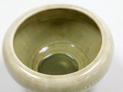 A Moorcroft pottery bowl, in a pale green glaze decorated with a raised band of vertical markings, impressed marks, 11cm high, 18.5cm diameter. - 2