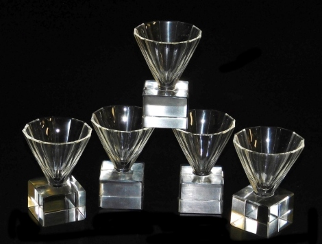 Five Art Deco Masonic firing glasses, with tapering faceted bowls, raised on square bases.