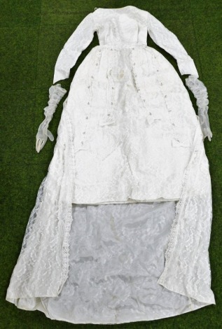 A vintage mid century white lace and pearl trimmed wedding dress, with gloves.