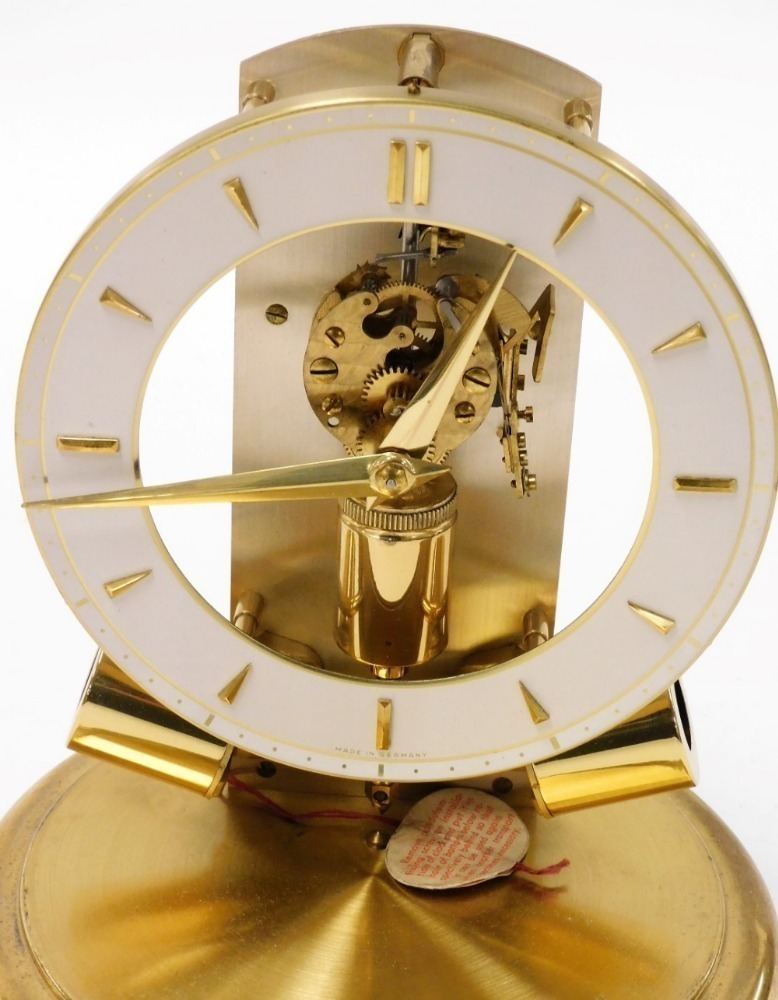 A Junghans 1000 day electric clock with visible escapement