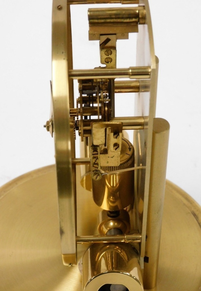 A Junghans 1000 day electric clock with visible escapement