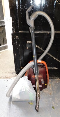 A Sebo Air Belt Vulcano vacuum cleaner, with accessories.