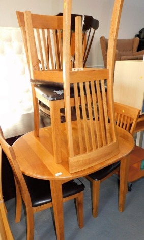 An oak extending dining table, 74cm high, the top 88cm x 80cm, with leaf, and four matching chairs with overstuffed seats. Lots 1501 to 1557 are available to view and collect at our additional premises SALEROOM NINE, Unit 9 Chandlers Yard, Grantham, NG31