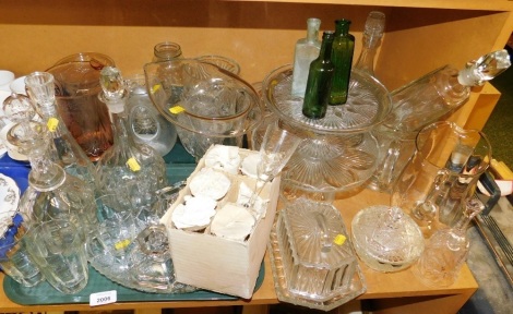 Various glassware, to include decanter, 30cm high, green glass bottles, 13cm high, butter dish, candlesticks, jugs, cake stands, jar and cover, hand bell, etc. (a quantity)