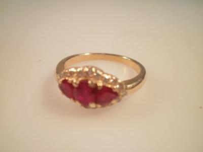 A three stone ruby and diamond dress ring