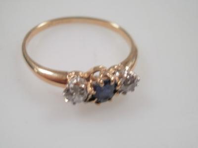 A three stone sapphire and diamond dress ring
