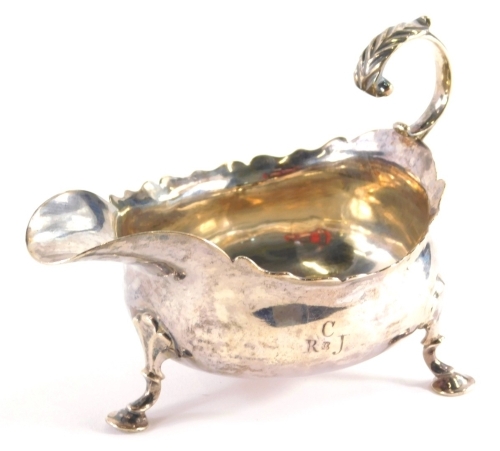 A George II silver sauce boat by James Crawford, with flying scroll handle, flared rim and triple hoof feet, Newcastle 1757, 12cm high. 4.5oz.