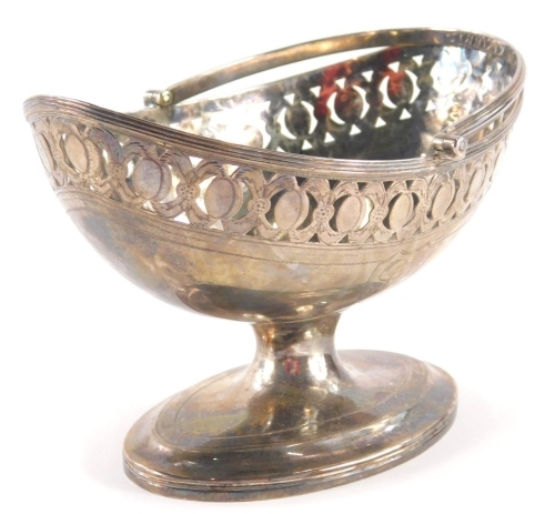 A George III silver sugar basket by John Robertson I, with fluted handle, oval part pierced bowl, inverted compressed stem and oval foot, Newcastle, c.1800, 17cm wide, 8oz.