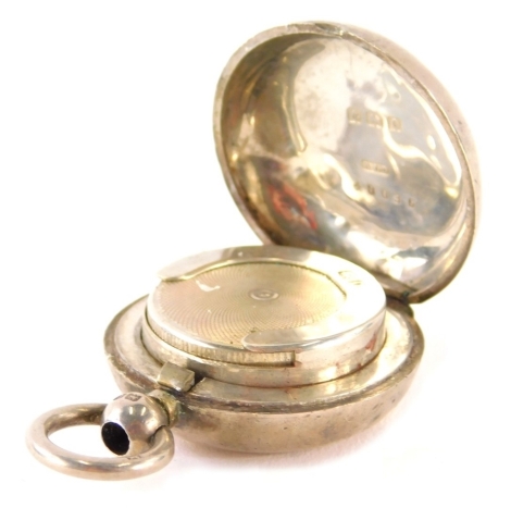 A George V silver sovereign case, of plain circular form with bright cut spring loaded interior, Birmingham 1913, 4cm high.