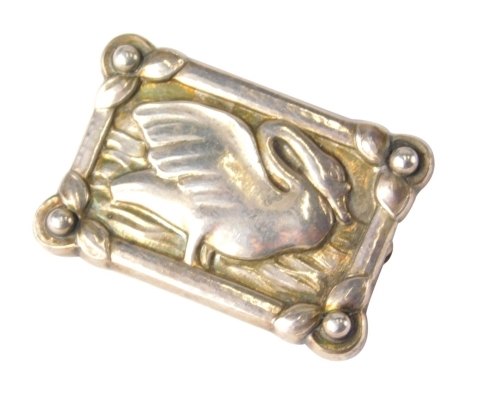 A George Jensen brooch, of rectangular form, centred by a swan, with plain pin back, marked verso Sterling Denmark, engraved and number 213A, 3cm wide, 6g.