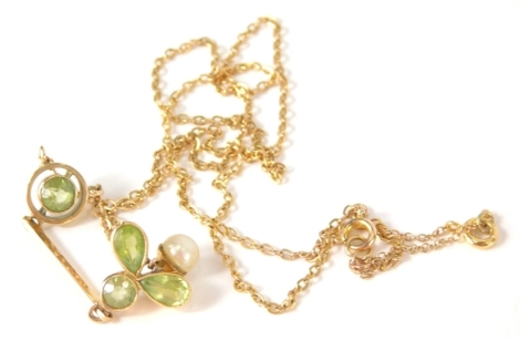 An Edwardian drop pendant, set with peridot and pearl of floral form, 4cm high, attached to a slender link necklace, in fitted case.