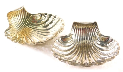 A pair of Victorian silver shell shaped salts, each of fancy pierced form with scroll handles, on compressed orb feet, Sheffield 1896, 13cm wide, 4.5oz. (2)