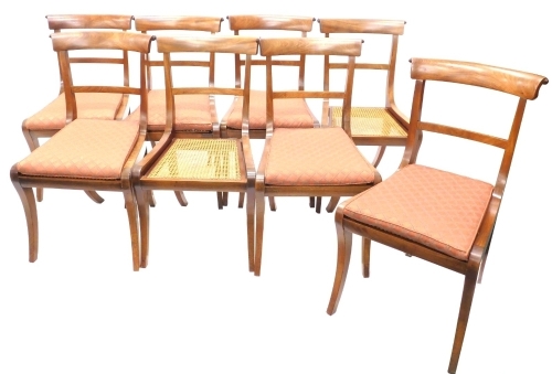 A set of eight Regency mahogany dining chairs, each with a bar back and cane seat on sabre legs.