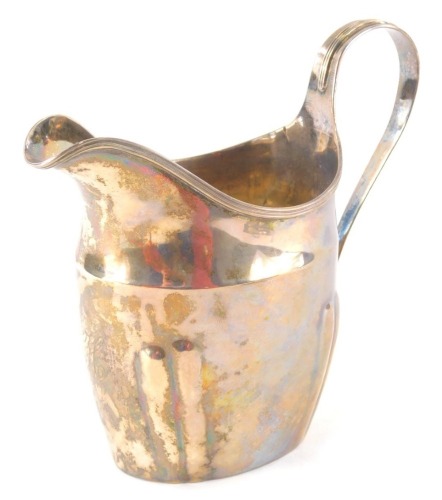 An early 19thC silver cream jug by Christopher Dinsdale I, with plain spout, strapwork handle and plain body, Newcastle, date mark rubbed, C.1800, 13cm high, 3.7oz.