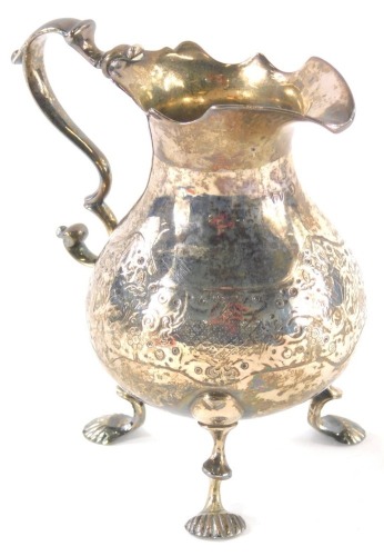 A George II silver cream jug, with flared rim, scroll handle, pear shaped body and triple inverted legs with shell feet, Newcastle 1754, 12cm high, 5oz.