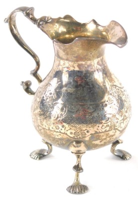 A George II silver cream jug, with flared rim, scroll handle, pear shaped body and triple inverted legs with shell feet, Newcastle 1754, 12cm high, 5oz.