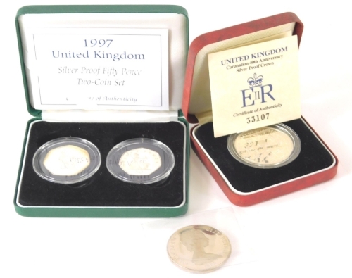 A cased Elizabeth II silver proof crown, boxed with paperwork and a proof 50 pence two coin set, World Cup 1982 crown. (3)