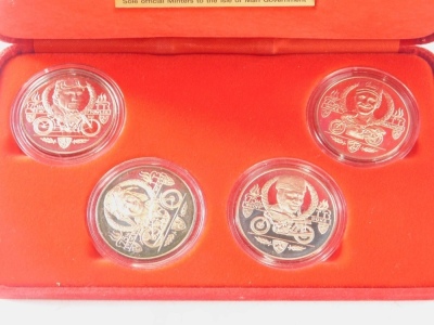 An Isle Of Man TT Races commemorative four coin set, and a George Stephenson £5 coin and note set. (2, cased) - 2