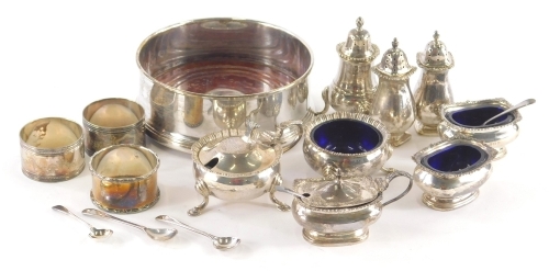 Various silver, silver plated ware, etc., an Elizabeth II pepper pot, with triple hoof feet and flame finial, 9cm high, an Elizabeth II bottle coaster, other mustard pots, silver plated napkin rings, et., various dates and makers. (a quantity)