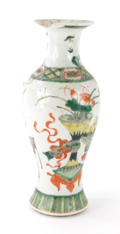 A Qing dynasty Chinese baluster vase, polychrome decorated with further vases, flowers and table, predominately in orange and green, double blue circle mark beneath, 25cm high.