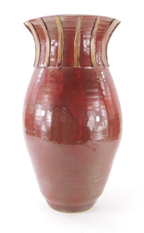 A West German pottery vase, of large proportion, in deep red glazes of inverted circular form, unmarked, 47cm high.