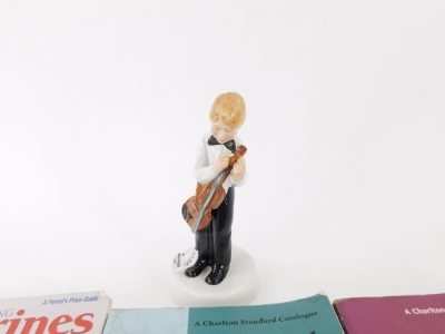 A Royal Doulton Childhood Days figure, I'm Nearly Ready, HN2976, printed marks beneath, 18cm high, and three reference books on Doulton figures, etc. (4) - 2