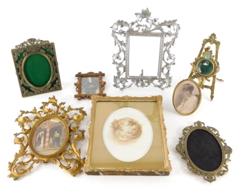 Various photograph frames, a small brass frame with circular glass front and shaped easel back, decorated with scrolls and flowers, 21cm high, and various other frames, portrait of a child, black and white photograph in Hogarth frame, etc. (a quantity)