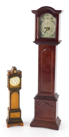 A 20thC miniature longcase clock, in mahogany finish case, Tempus Fugit type, 40cm high, and another smaller. (2)