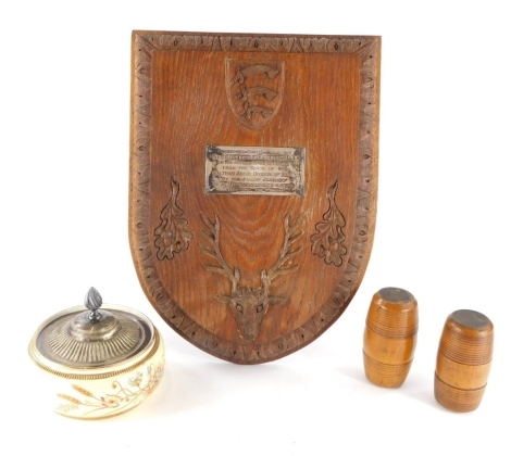 Various treen, an oak backed plaque with easel back, from the bench of the Waltham Abbey division of Essex, two turned barrels and a pottery preserve jar with plated lid, 13cm diameter.