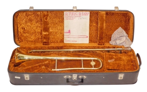 A Boosey and Hawkes York brass trombone, fitted case, the case 93cm wide.