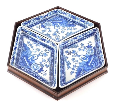 A Wedgwood blue and white pottery hors d'oeuvre set, comprising three diamond shaped dishes, in shaped outer wooden case, impressed marks beneath, 35cm wide.