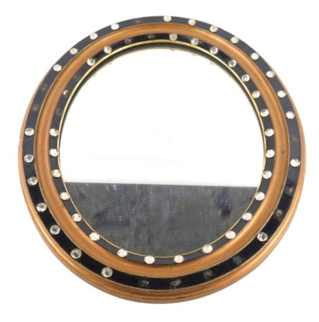 A 19thC Irish gilt and ebonised oval mirror, the frame set with faceted glass jewels, 48cm x 57cm. (AF)