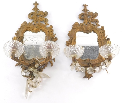 A pair of girandole wall sconces, each with electric fittings, glass dish holders, and shaped mirrors, 34cm high.