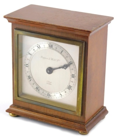 A Mappin and Webb mahogany cased mantel clock, with Elliot movement, silvered, 9cm wide back plate with Roman Numeric chaptering, on compressed bun feet with hand wind movement, 16cm high.