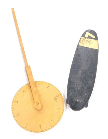 A beech trundle wheel, 97cm high and a vintage wooden skateboard in black and cream, numbered 7 (2).