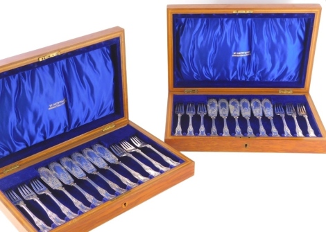 A cased set of silver plated fish eaters, in Batty & Sons oak canteen, shell capped kings pattern, extra blades, the canteen, 40cm wide and another similar, 12 place settings in total (2).