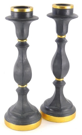 A pair of Emily Readett-Bayley Limited candlesticks, in black and gilt colours, 44cm high.