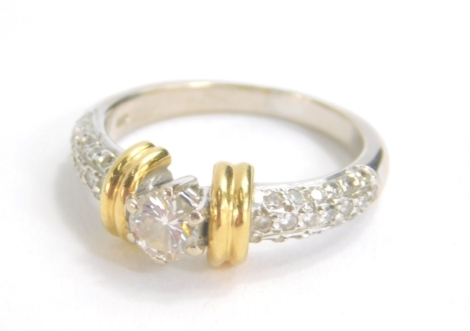 An 18ct yellow and white gold single stone diamond ring, the central stone approx. 0.45 carat, with pave set diamond shoulders, size P, 7.5g all in.