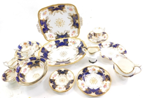 Various Coalport teaware, serving plate 25cm wide, cabinet cup, saucers, flared saucer, etc, each piece gilt highlighted and decorated with panels of flowers, printed marks beneath. (a quantity)