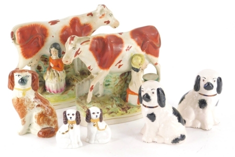 A pair of 19thC Staffordshire milk maid and cow groups, polychrome decorated, 20cm high, a pair of Staffordshire dogs in black sponge colourway, a pair of miniature dogs, etc. (a quantity)