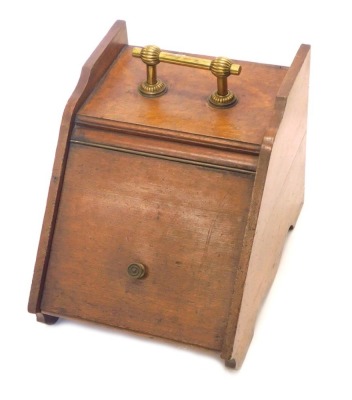 A late 19thC oak coal scuttle, with a turned brass handle, 33cm wide.