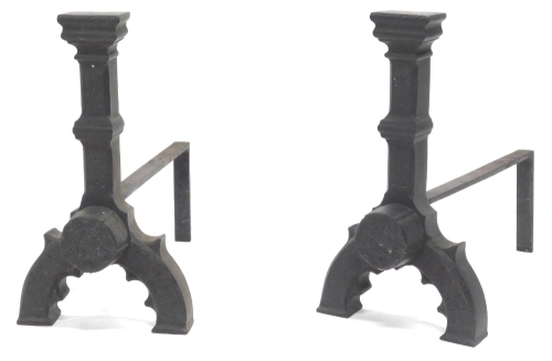 A pair of large cast iron fire dogs, each decorated with a rose on inverted 'U' shaped supports, 44cm high.