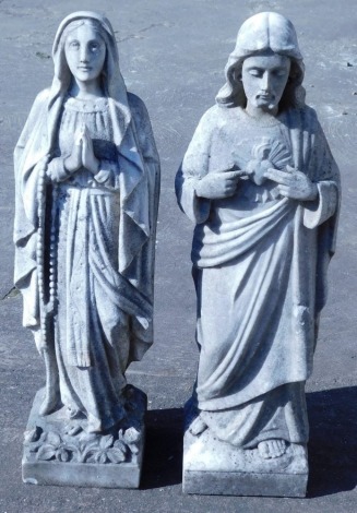 Two similar carved marble statues, in the form of Jesus Christ and Mary, each on a square base, 62.5cm high.