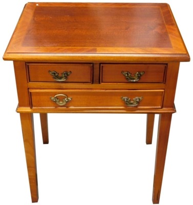 A mahogany small occasional table, the rectangular cross banded top with a chequer border above two short and one long drawer, each with brass handles on square tapering legs, 54cm high, 45cm wide.