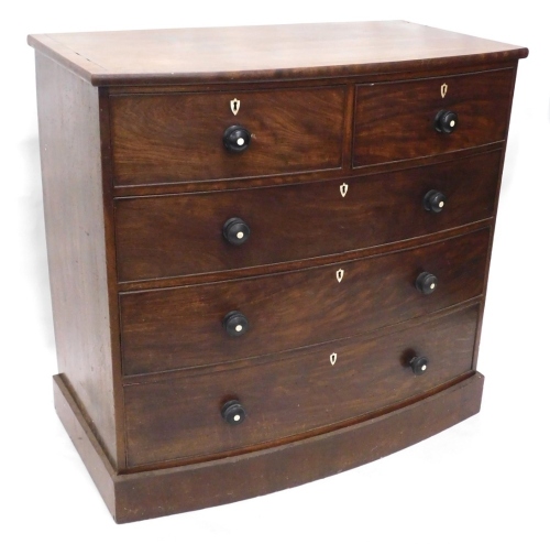 A Victorian mahogany and ebony strung bow fronted chest of drawers, the top with a cross banded border above two short and three long drawers, each with ebonised handles and bone escutcheons, on a plinth, 110cm high, 115cm wide.