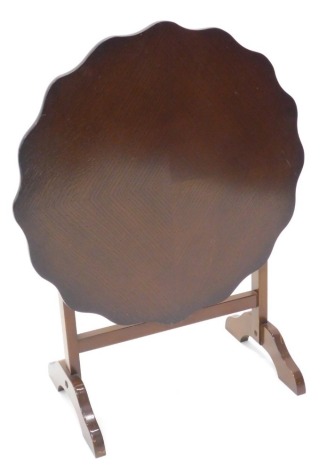 An oak folding occasional table, with a shaped quarter veneered top, 50cm wide.