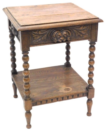 A late 19th/early 20thC oak side table, the rectangular top with a moulded edge above a carved frieze drawer, on bobbin turned supports with under tier, approx 77cm high, 55cm wide.