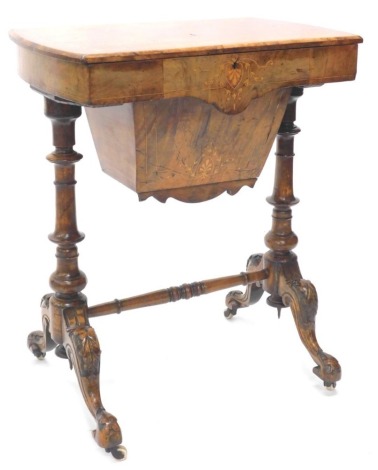 A Victorian walnut and marquetry work table, the rectangular quarter veneered top with a moulded edge enclosing a fitted interior on turned end supports with splayed feet and ceramic castors, 59cm wide.