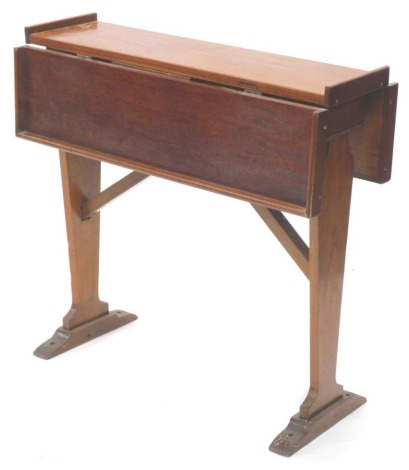 A teak ship's drop leaf table, with a raised gallery on end supports with brass mounts for bolts or screws, 75cm wide.