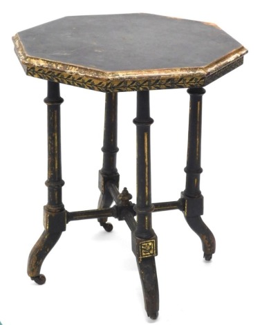 A Victorian ebonised and parcel gilt Aesthetic movement occasional table, the octagonal top with a moulded edge on turned and fluted supports, X stretcher and splayed legs terminating in ceramic castors, 62cm high, 50cm diameter.